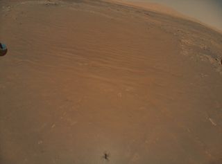 NASA's Ingenuity helicopter captured this image of the Perseverance rover during its 11th flight on the Red Planet, on Aug. 5, 2021.