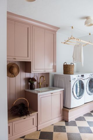 a laundry room with a raised washer dryer