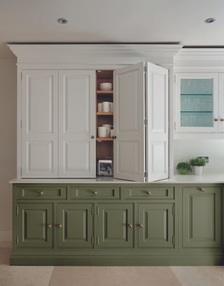 green and white kitchen with green units and white painted cabinetry