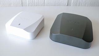 Wyze Mesh Router next to Wyze Mesh Router Pro on a table