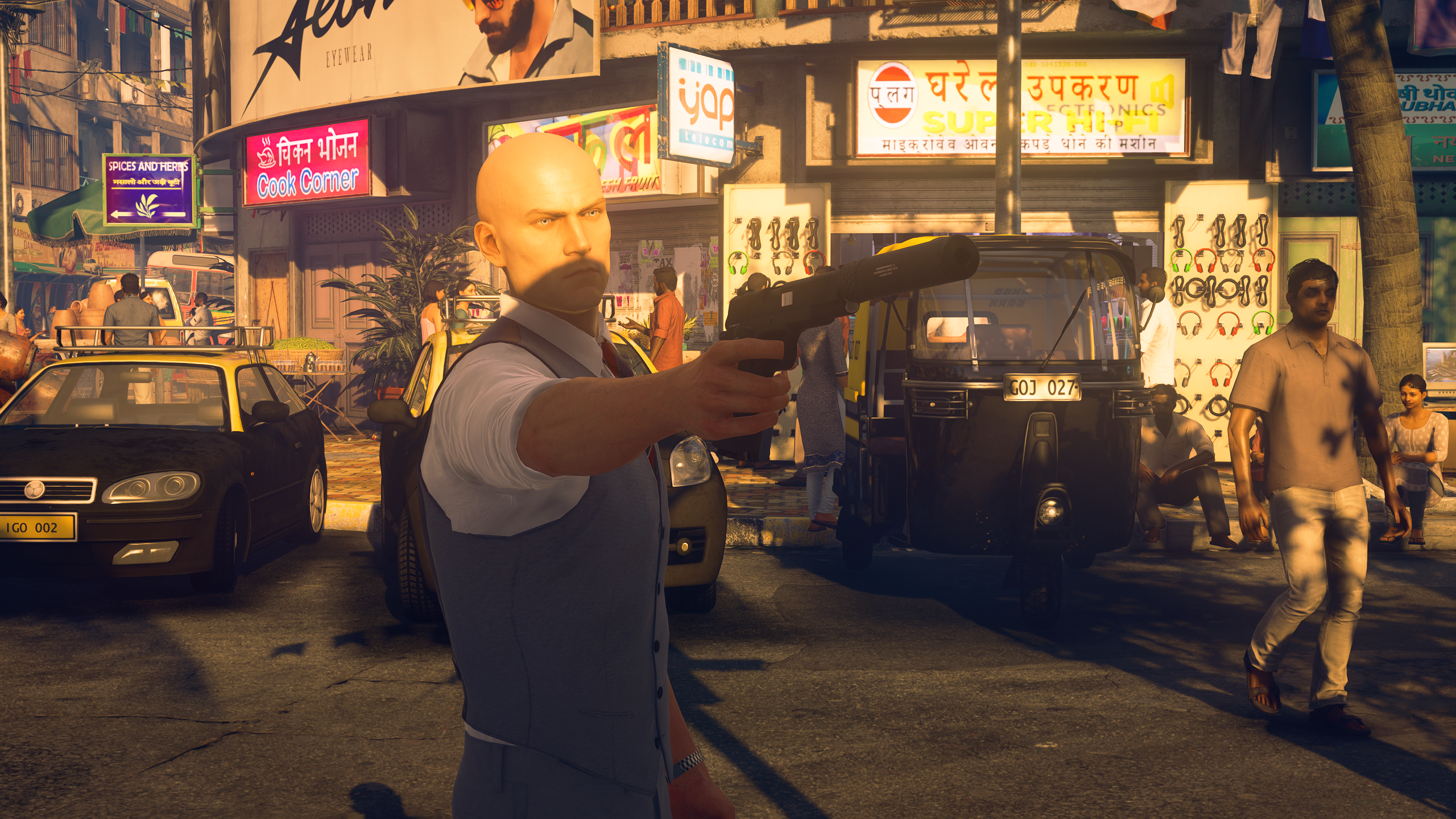 Agent 47, face half-shadowed, aims a pistol ahead of him.