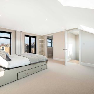 modern loft conversion bedroom with balcony and en suite