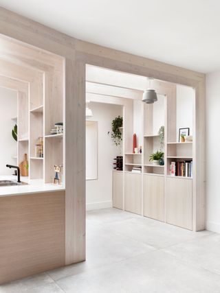 a kitchen extension with pendant lights attached to exposed rafters