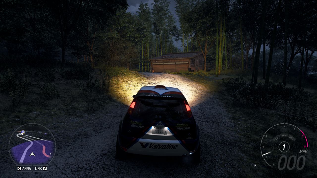 Forza Horizon 6 Barn Finds: A player parked outside an old wooden barn on a wooded hillside at night.