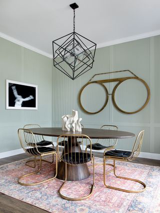 sage green dining room with modern round dining table