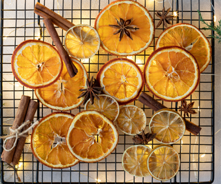 Dried oranges and cinnamon on a wire rack