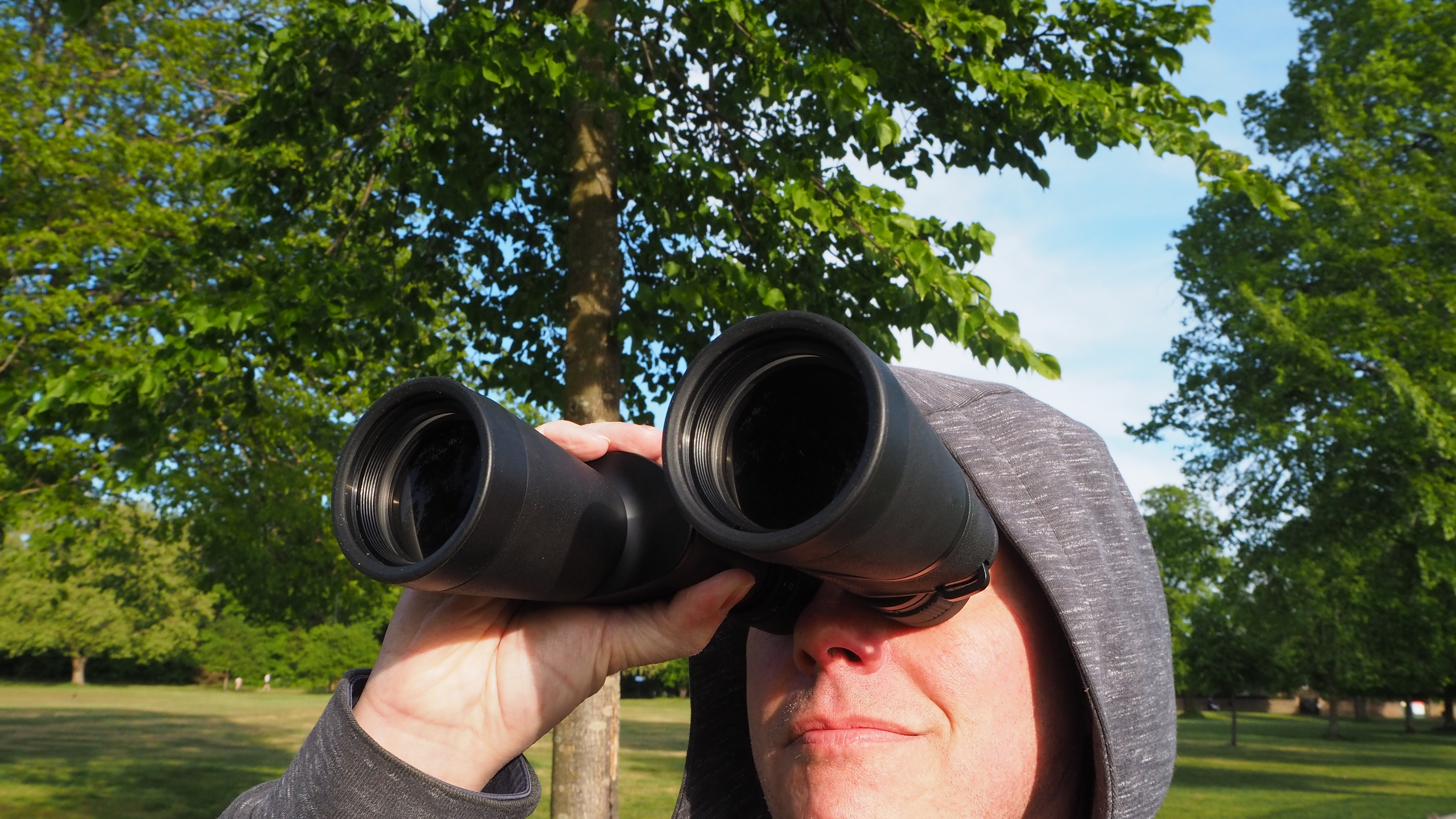 Person looking through Nikon Action Zoom 10-22x50 binoculars