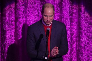 Prince William, Duke of Cambridge gives a speech on stage as he attends a special pantomime performance at London's Palladium Theatre
