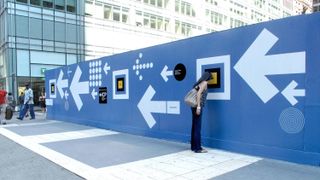 Doyle Partners designed a barricade at the International School of Photography that housed a mini photo exhibition viewed only through peepholes