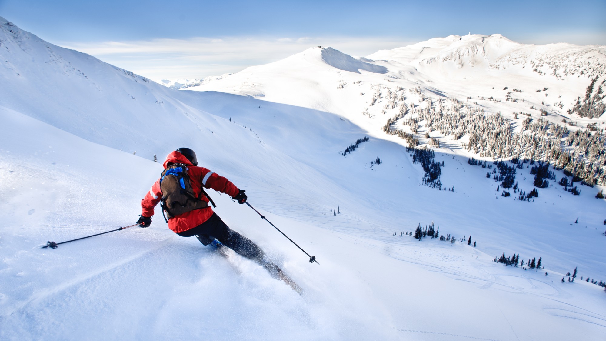Man skiing off-piste overlooking a valley