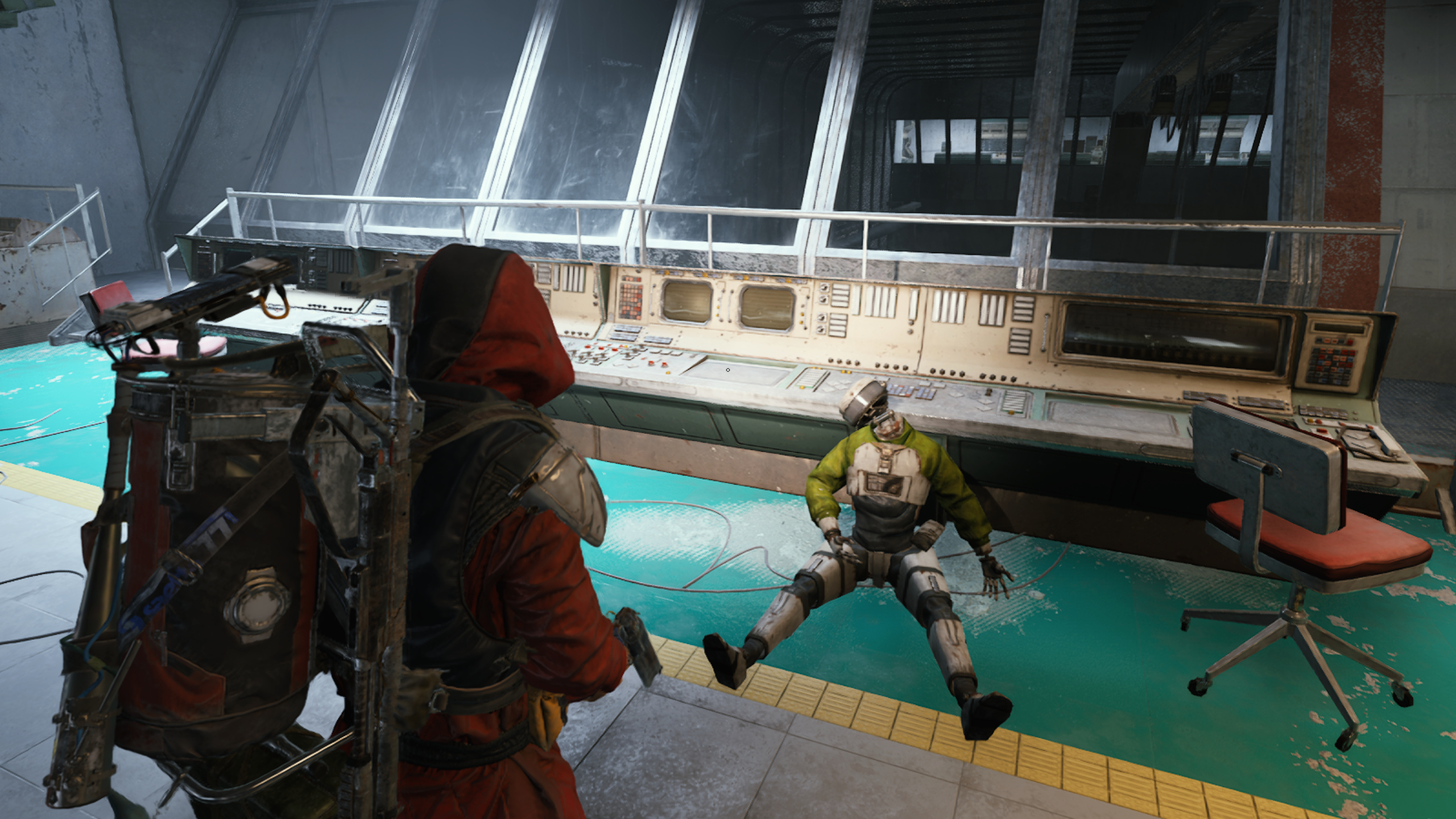 Arc Raiders quests: A player looking at a desk of computers in a control room, with a dead robot slouched next to it.