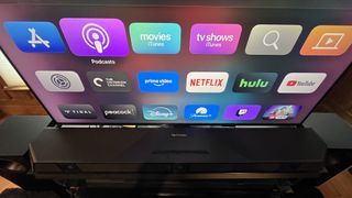 Nakamichi Dragon soundbar seen from above with Apple TV 4K menu on TV screen