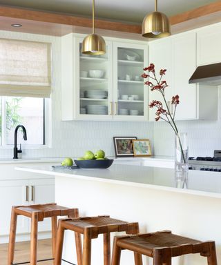 Modern white kitchen ideas with shaped tile backsplash and island with wooden stools