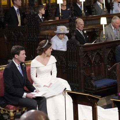 WINDSOR, ENGLAND - OCTOBER 12: Princess Eugenie and her husband Jack Brooksbank, look back towards the Duke of York and Sarah, Duchess of York (seated front) and Queen Elizabeth II, the Duke of Edinburgh, Prince of Wales, the Duke and Duchess of Cambridge, and the Duke and Duchess of Sussex, during their wedding at St George's Chapel in Windsor Castle on October 12, 2018 in Windsor, England. (Photo by Danny Lawson - WPA Pool/Getty Images)