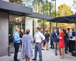 guests in outside space of Stanton Williams-designed Hampstead Heath home