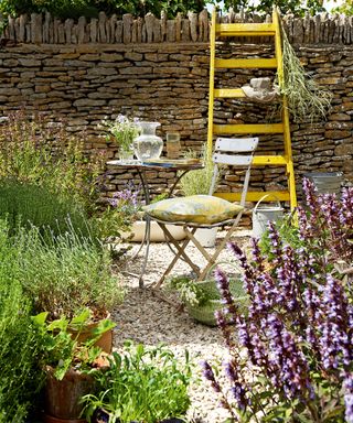 Patio planting ideas with herbs in a small patio with bistro table and chairs.