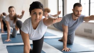 a woman doing yoga in a class setting