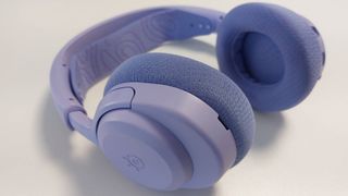 The SteelSeries Arctis Nova 3 X seen on a desk. This is the Lavender colourway.
