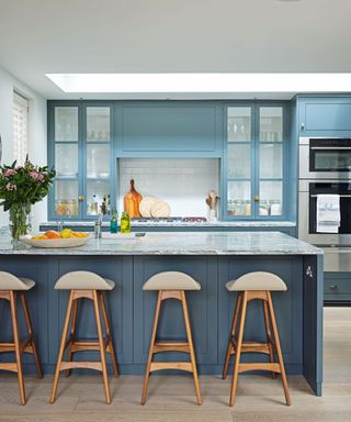 Kitchen with blue cabinetry and peninsula island