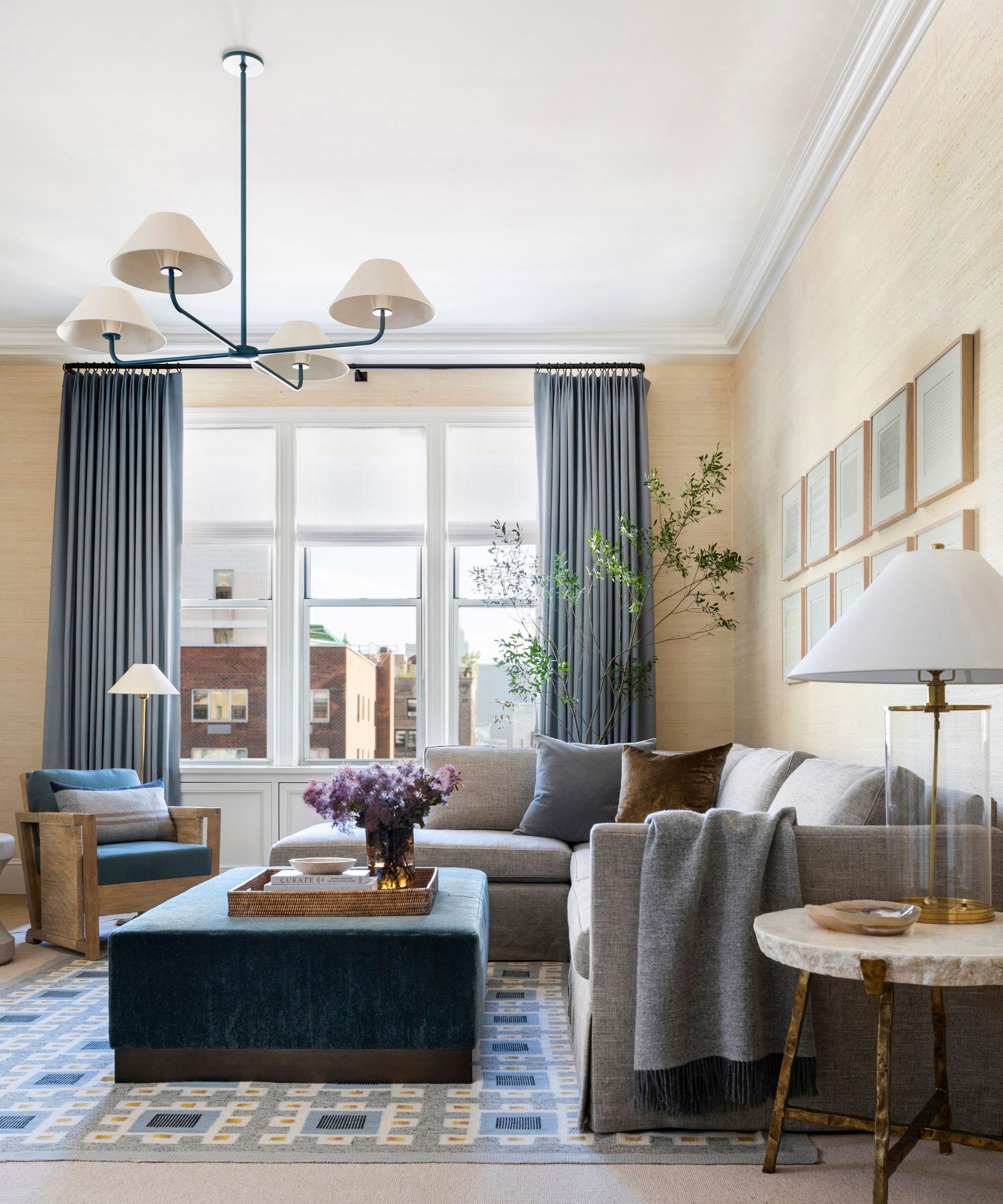 Living room given a relaxing feel with luxurious throw pillows and blankets, and a blend of soft textures and natural wood tones