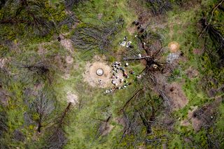 Aerial view of Xhosa ceremony in the middle of a grassland