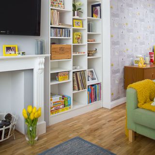 living room with funky wallpaper and wooden flooring
