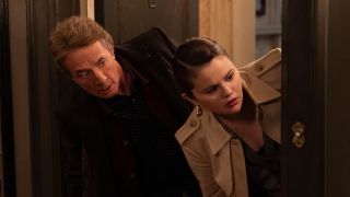 Oliver (Martin Short) and Mabel (Selena Gomez) peek their heads outside a door on Only Murders in the Building.