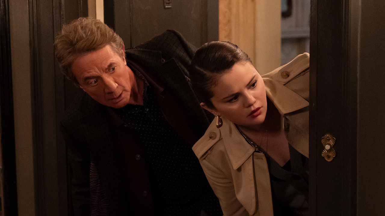 Oliver (Martin Short) and Mabel (Selena Gomez) peek their heads outside a door on Only Murders in the Building.