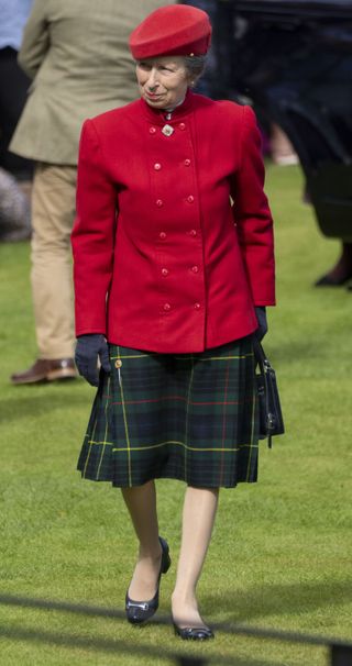 Princess Anne paired a bright red jacket with a matching beret and tartan skirt