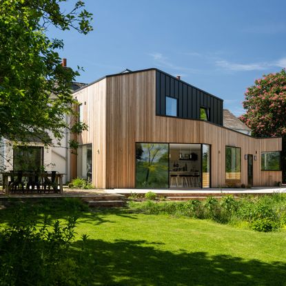 Exterior of Victorian cottage with rear extension featuring larch wooden cladding