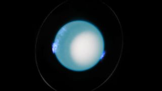 an image of Uranus with blue auroras visible around its surface