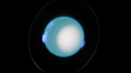 an image of Uranus with blue auroras visible around its surface
