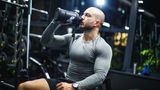 Man drinking a pre-workout in the gym
