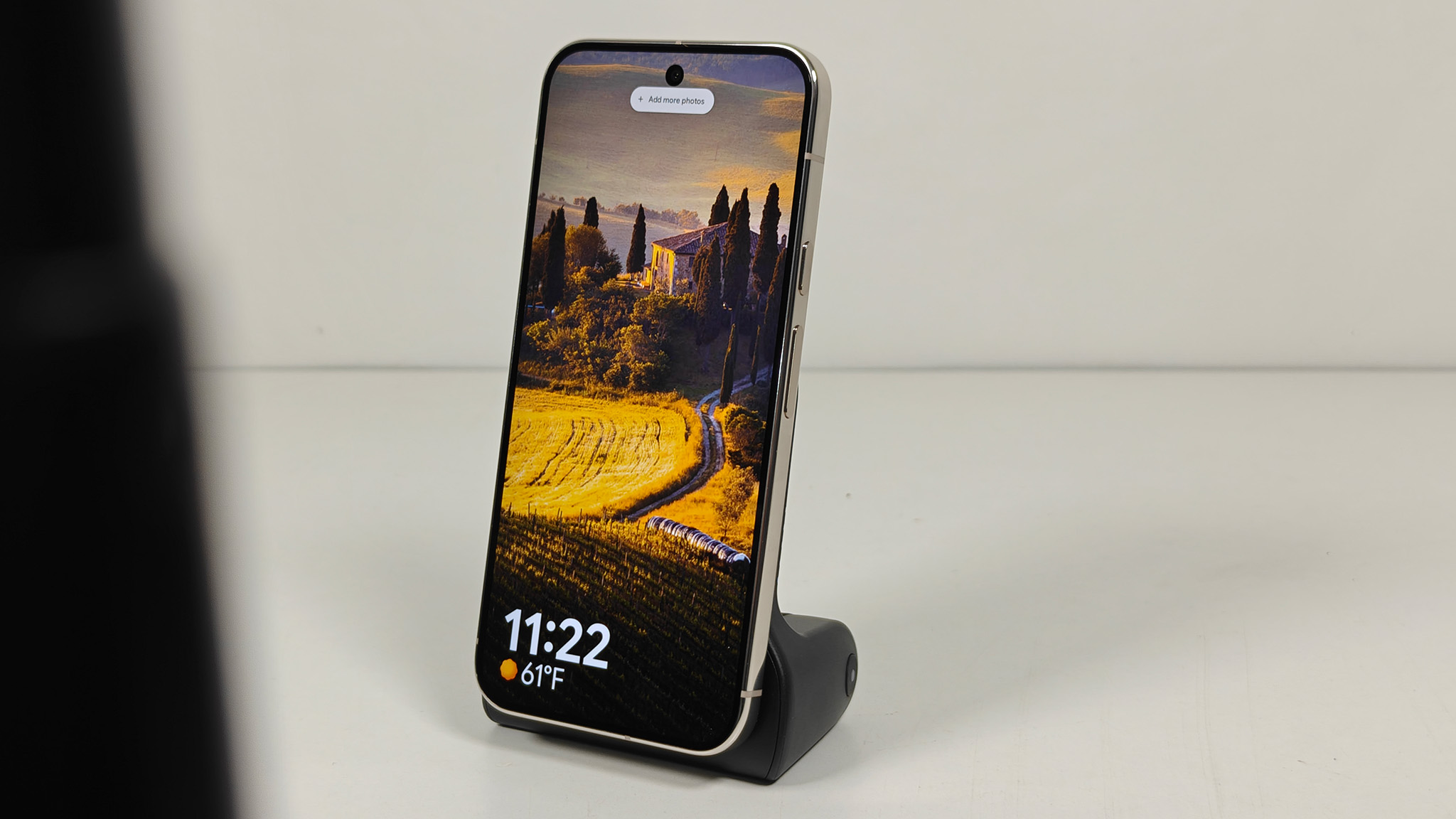 A KraftGeek magnetic camera grip attached to a Google Pixel 10 Pro XL, using the Pixel 10 Screensaver function while wirelessly charging