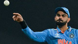 Leading run scorer Virat Kohli reaches out to catch the ball ahead of the India vs Australia live stream