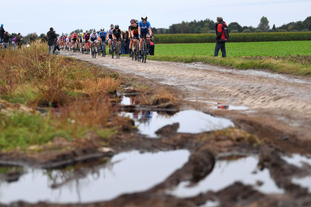 ROUBAIX FRANCE OCTOBER 02 A general view of Lotte Kopecky of Belgium and Team Liv Racing Aude Biannic of France and Movistar Team and the peloton compete through cobblestones sector during the 1st ParisRoubaix 2021 Womens Elite a 1164km race from Denain to Roubaix ParisRoubaixFemmes ParisRoubaix on October 02 2021 in Roubaix France Photo by Tim de WaeleGetty Images