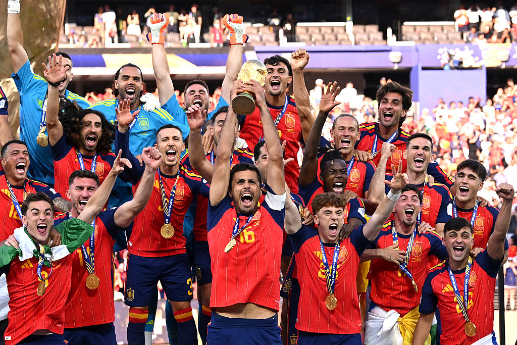 EAST RUTHERFORD, NEW JERSEY - JULY 19: Rodri #16 of Spain lifts the FIFA World Cup Winner&amp;rsquo;s Trophy alongside U.S. President Donald Trump and FIFA President Gianni Infantino after the team&amp;rsquo;s victory following during the FIFA World Cup 2026 Final match between Spain and Argentina at New York New Jersey Stadium on July 19, 2026 in East Rutherford, New Jersey. (Photo by David Ramos/Getty Images)