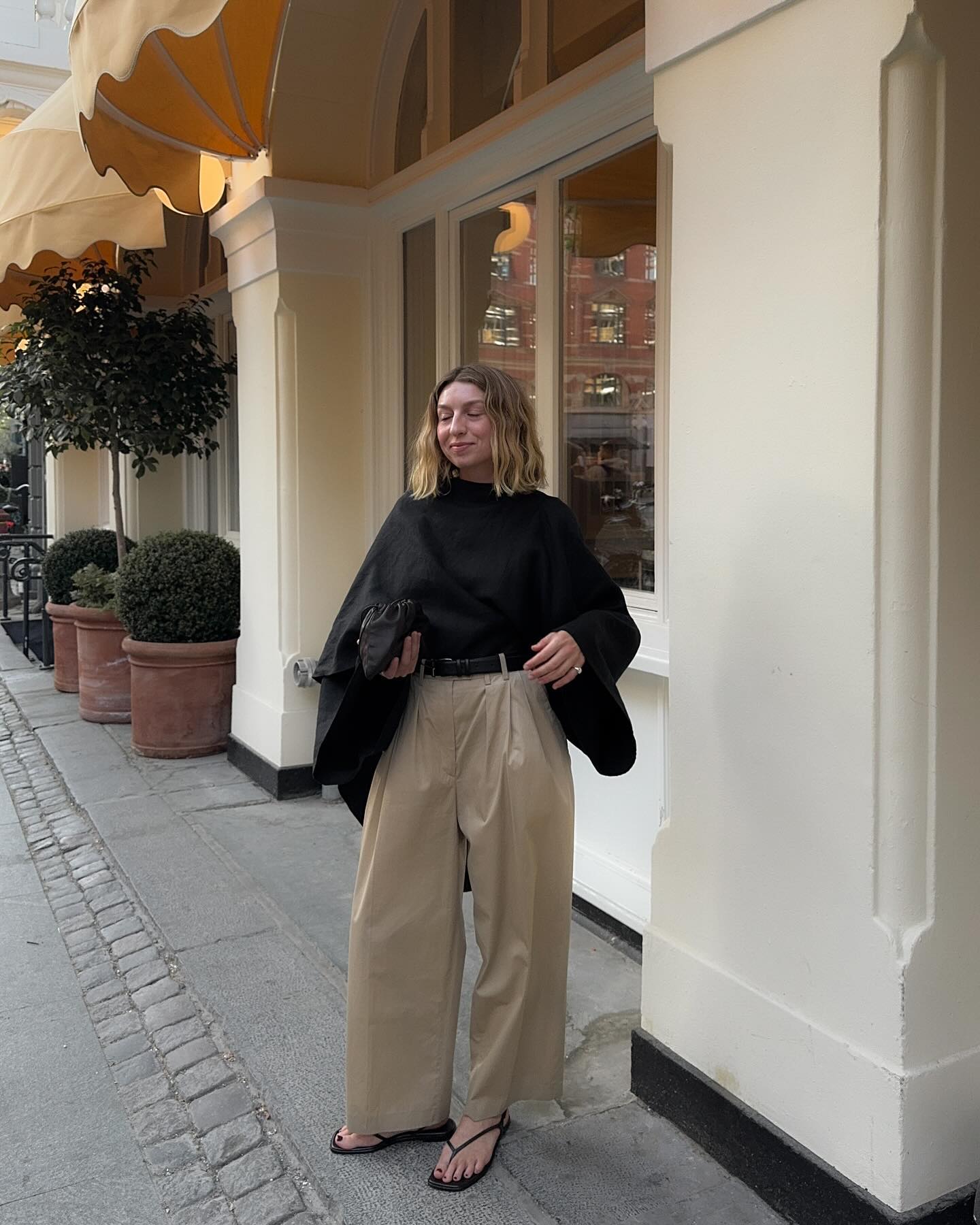 Influencer wears square toe flip flops.