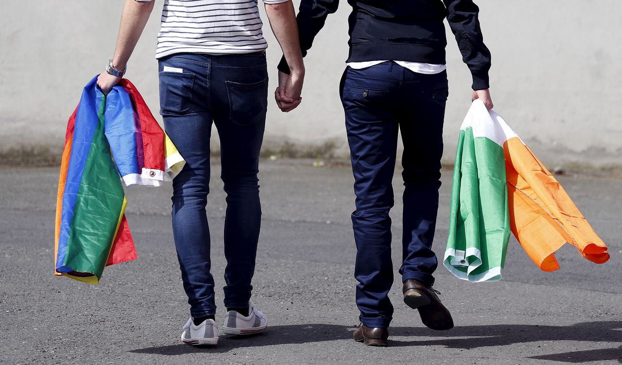 A couple walks hand-in-hand in Dublin.