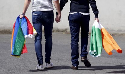 A couple walks hand-in-hand in Dublin.