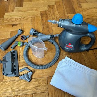 bissell steamshot with accessories on wood flooring