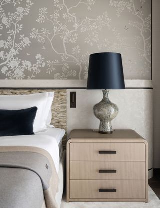 Modern bedroom with floral silver wall and wood bedside table