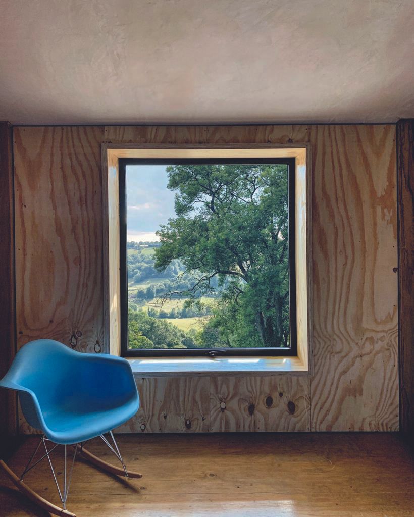Rough and raw finishes still reign throughout the home, including bare plaster and ply timber cladding. The large sliding doors, from Smart Systems, on both sides of the house draw back to expose the main living area to the elements completely in the summer.