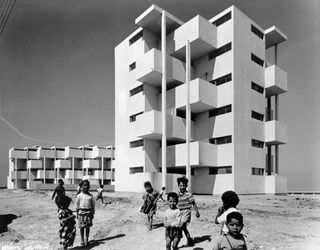 Black and white picture of children in front of building