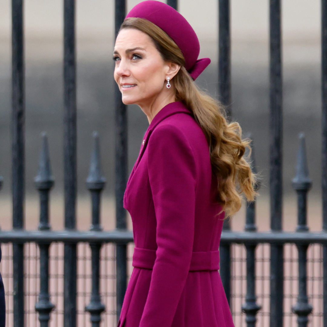 Kate Middleton wearing a berry coat and hat