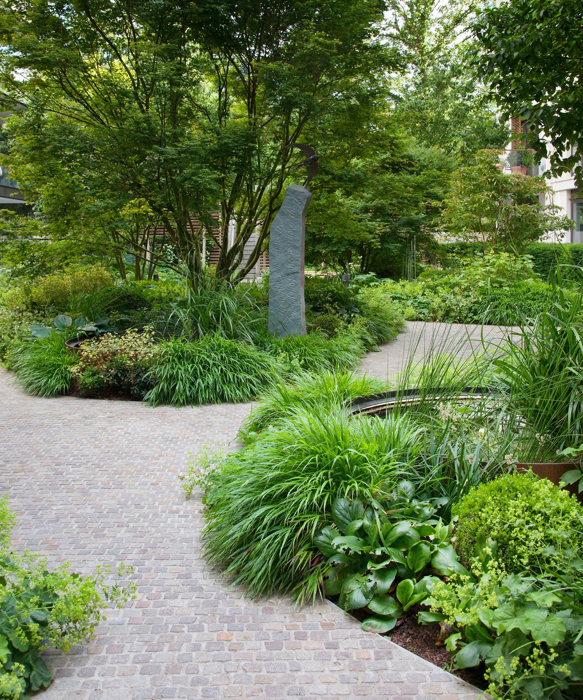 stone curving path in lush garden