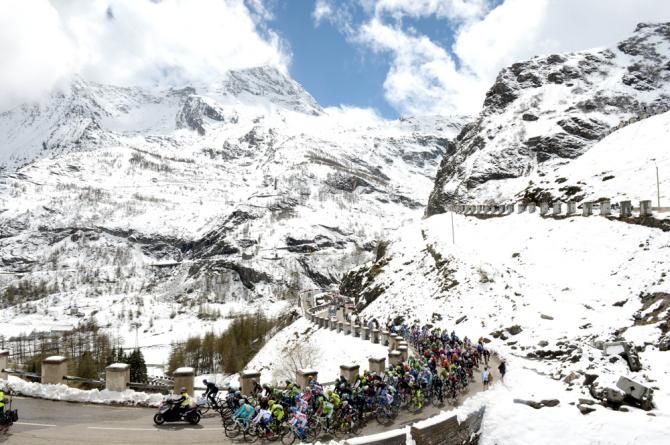 The peloton climb through the snow on stage 15