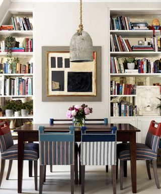 Cream dining room with two alcoves filled with books