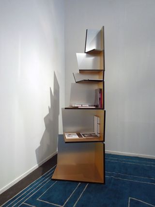 View of 'Totem' by Martino Gamper - a black and silver bookshelf with several books on it