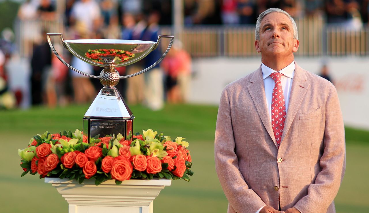 Jay Monahan looks to the sky next to the FedEx Cup